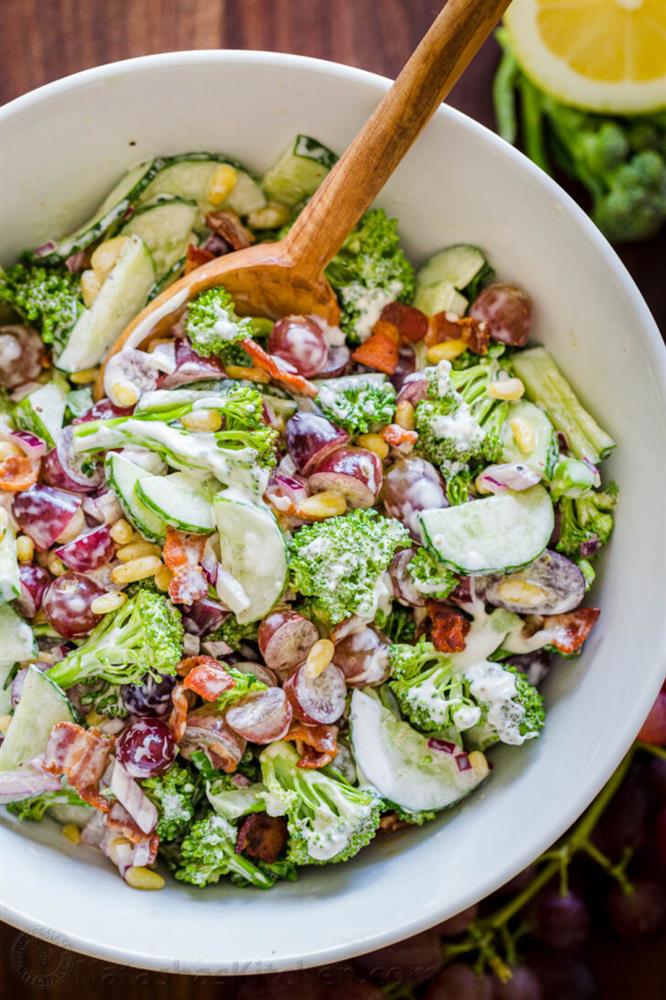 : A bowl full of cheese and cream salad and vegetables